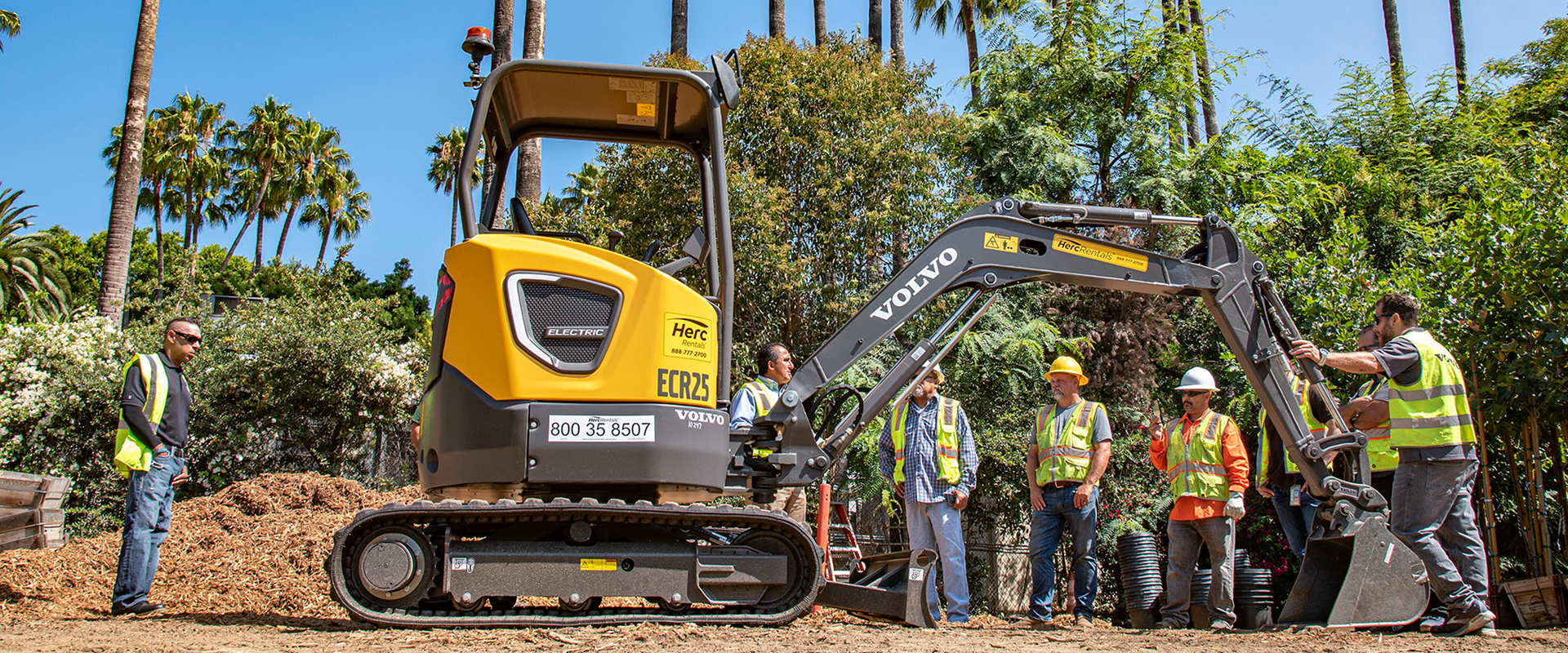Crew and heavy machinery excavating dirt