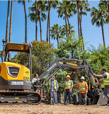Crew and heavy machinery excavating dirt