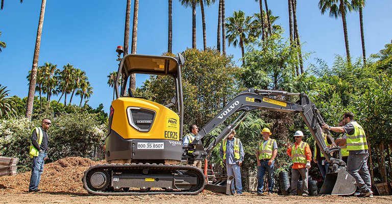 Crew and heavy machinery excavating dirt