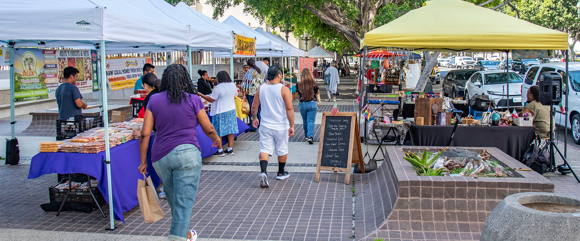 People exploring a farmers market in LA