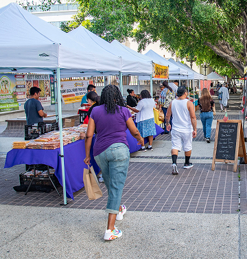 People exploring a farmers market in LA