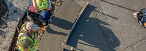 Crew inspecting sidewalk construction work